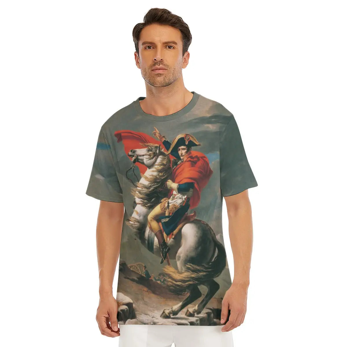 Male model wearing the Napoleon Crossing the Alps All-Over Print T-shirt showcasing Jacques-Louis David's dramatic equestrian portrait with Napoleon pointing skyward on his rearing stallion against the Alpine backdrop