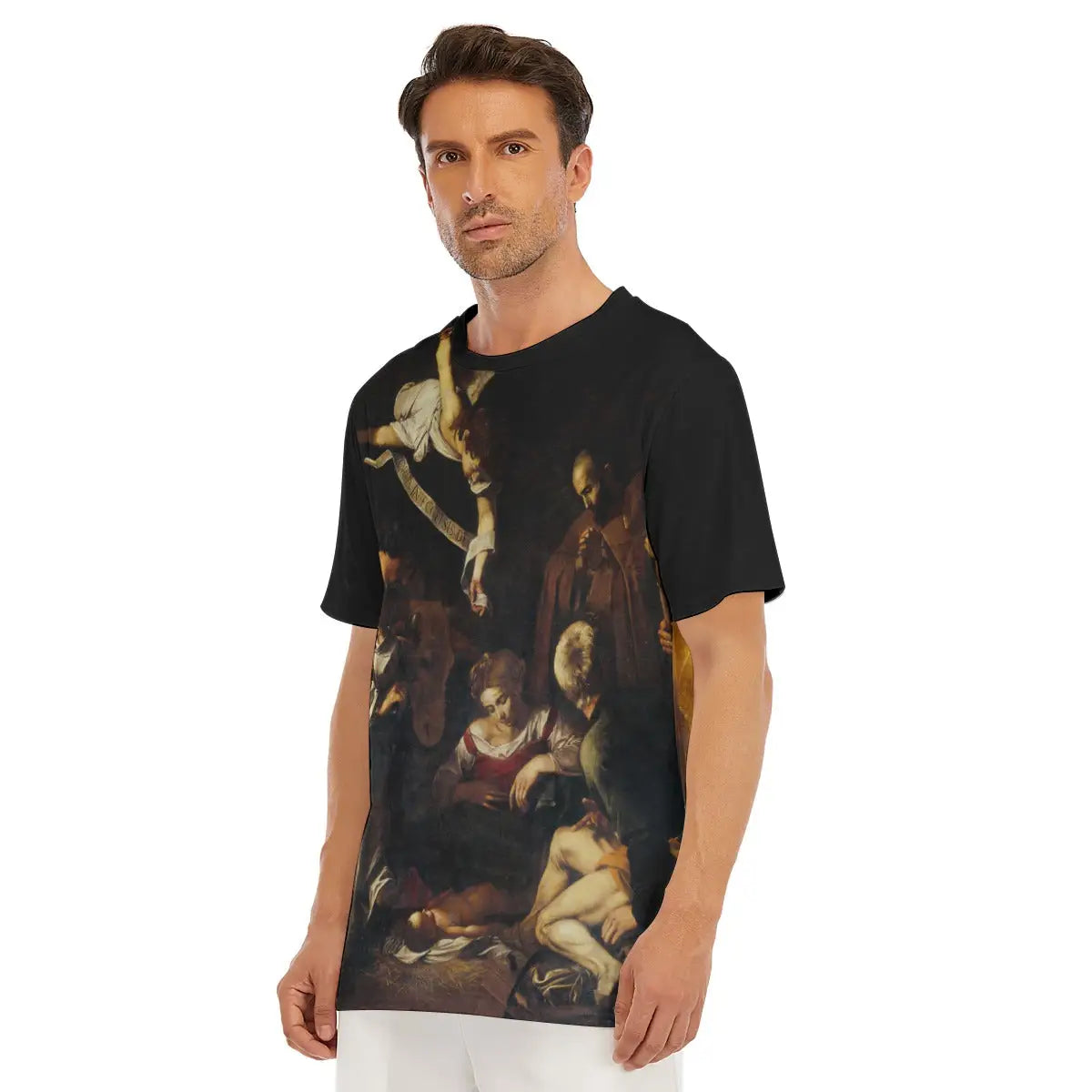 Caravaggio Nativity T-shirt laid flat, displaying the entire sacred masterpiece, premium craftsmanship, and natural texture of the 100% cotton fabric that enhances the devotional quality of the reproduced painting stolen from the Oratorio di San Lorenzo.