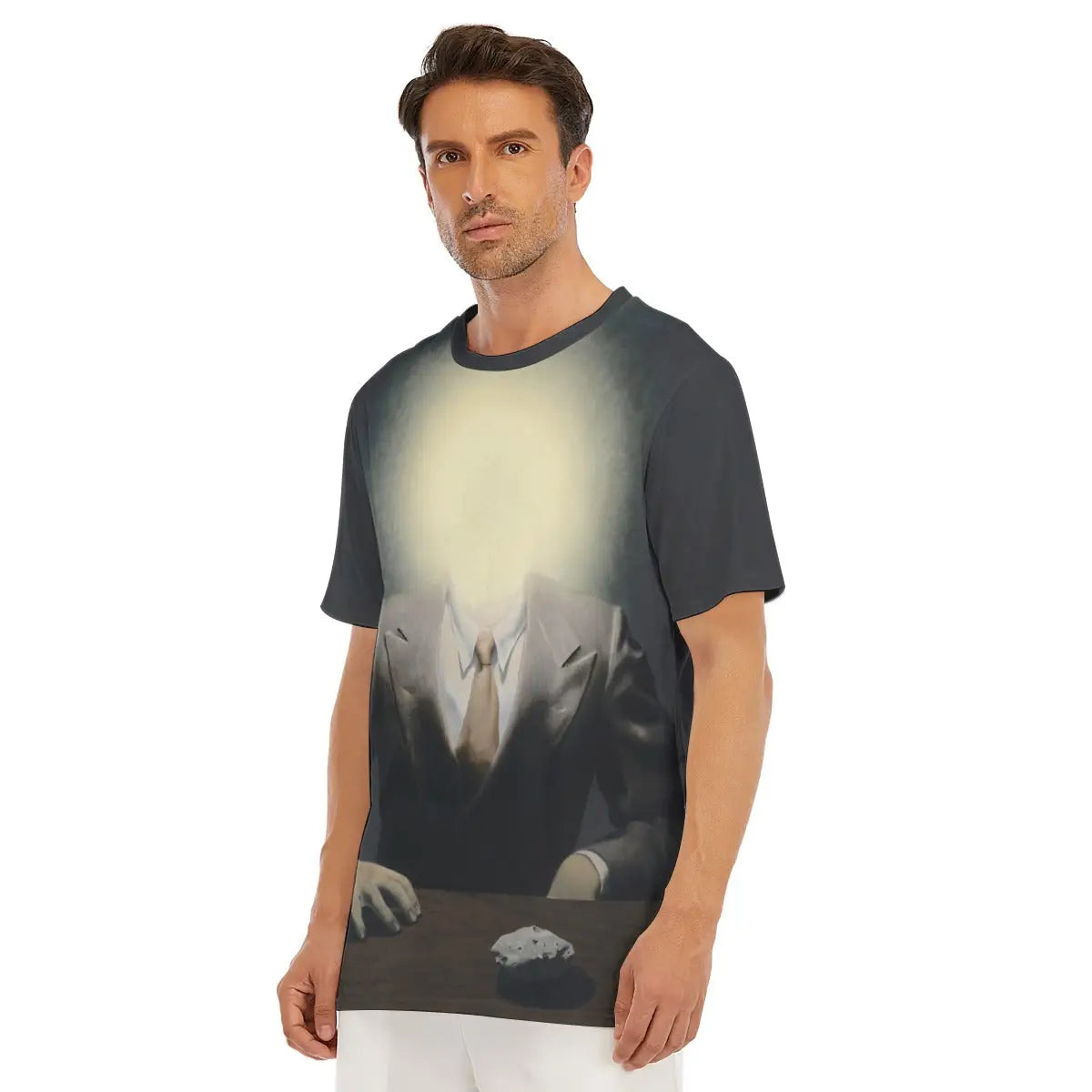 Close-up detail of high-quality printing on 100% cotton The Pleasure Principle T-shirt, showcasing the photorealistic details of the formal suit juxtaposed with the brilliant, ethereal glow that replaces the subject's face in Magritte's surrealist masterpiece