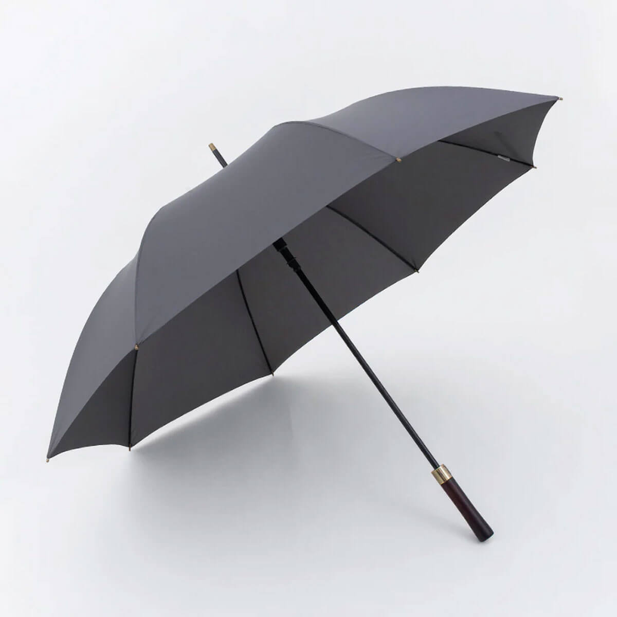 Vintage-style wooden handle umbrella with large canopy.