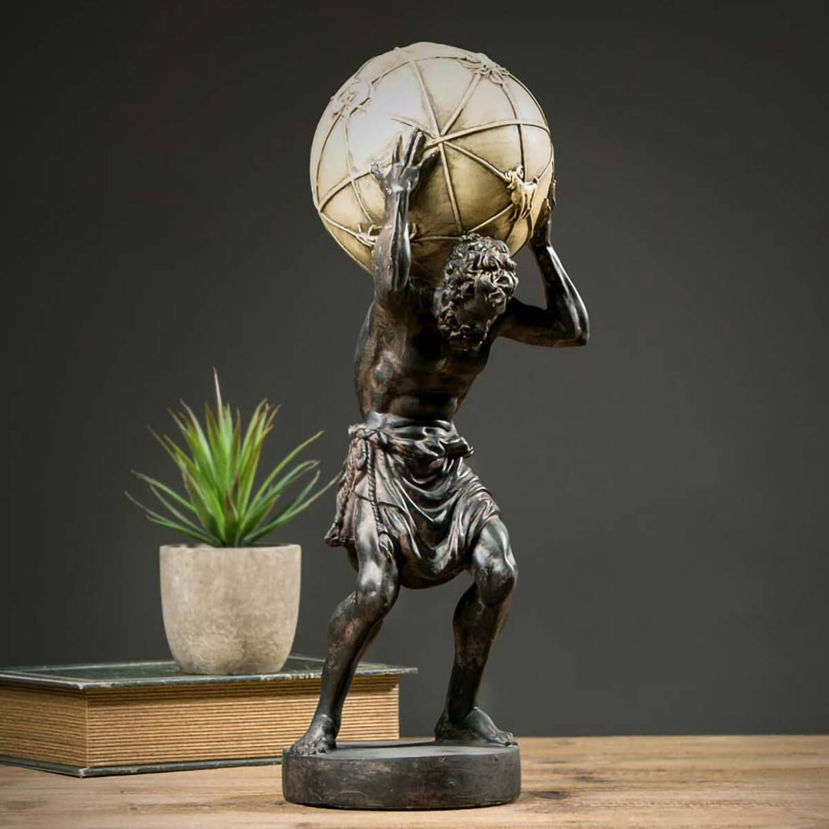 Mystical world sculpture with Atlas figure