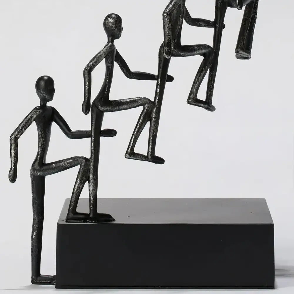 Close-up of Modern Minimalist Sculpture's detailed figures climbing upward