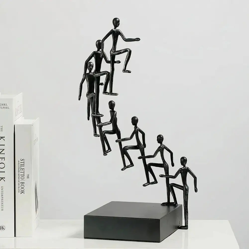 Modern Minimalist Sculpture showing 8 figures climbing stairs to success, made from zinc alloy and iron