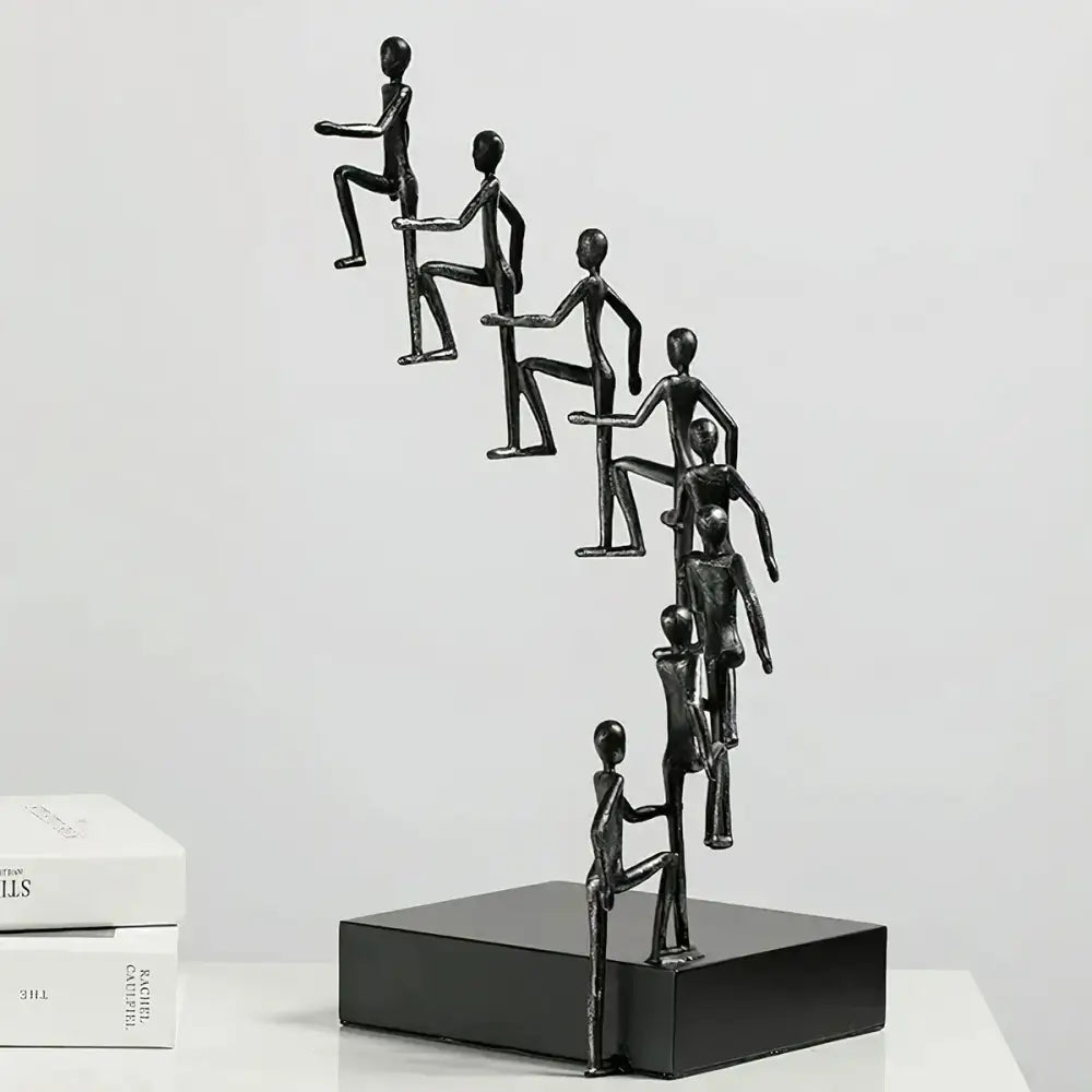 Side view of Modern Minimalist Sculpture displaying ascending figures in metallic finish