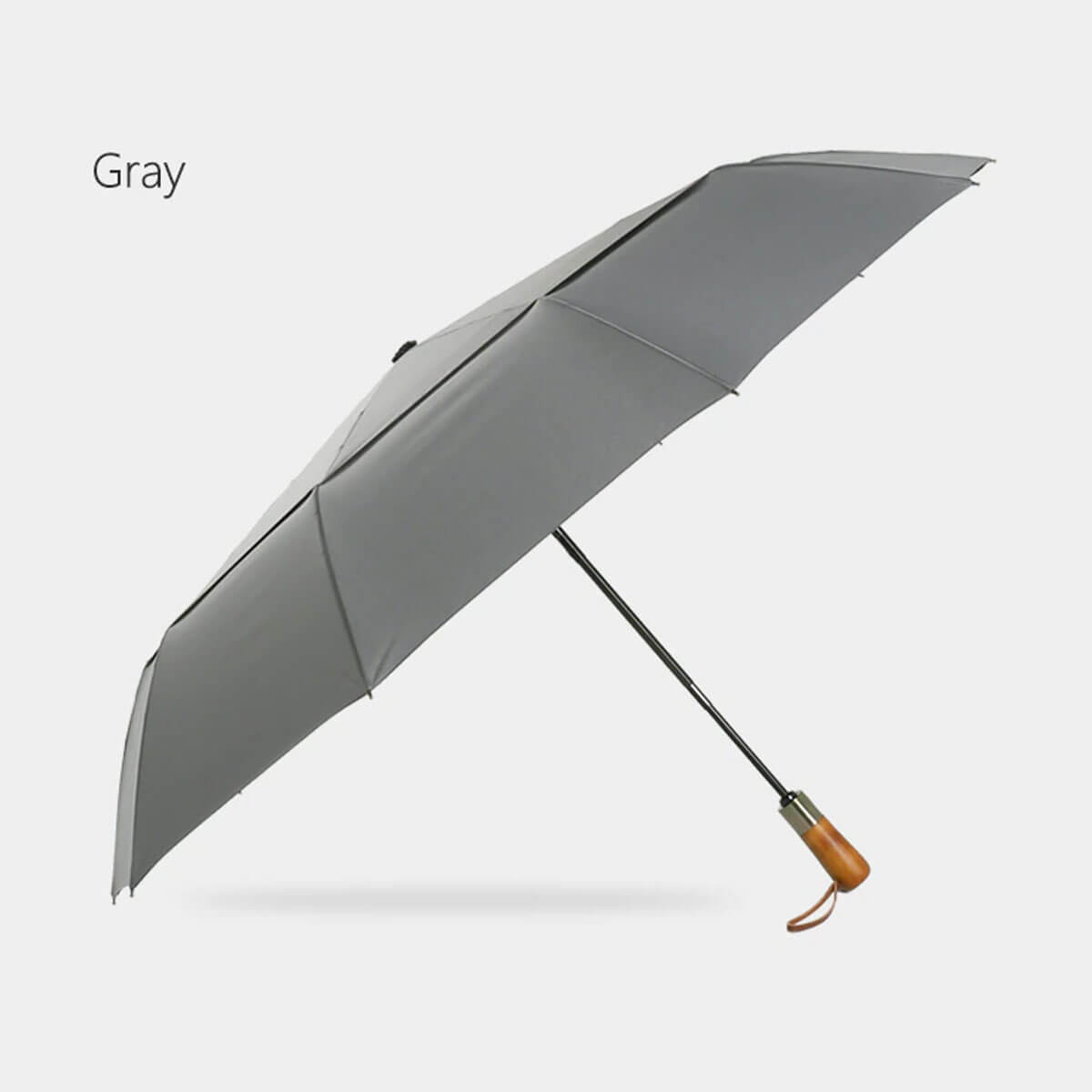 Compact folded umbrella next to its protective sleeve