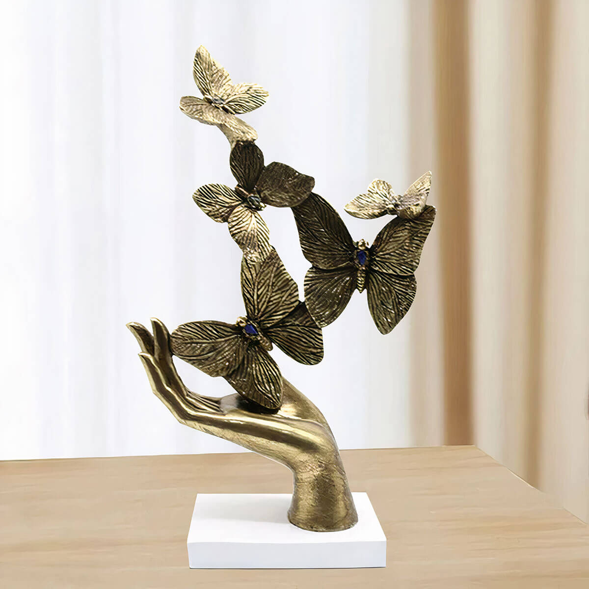 Modern gold butterfly sculpture on stylized palm leaf