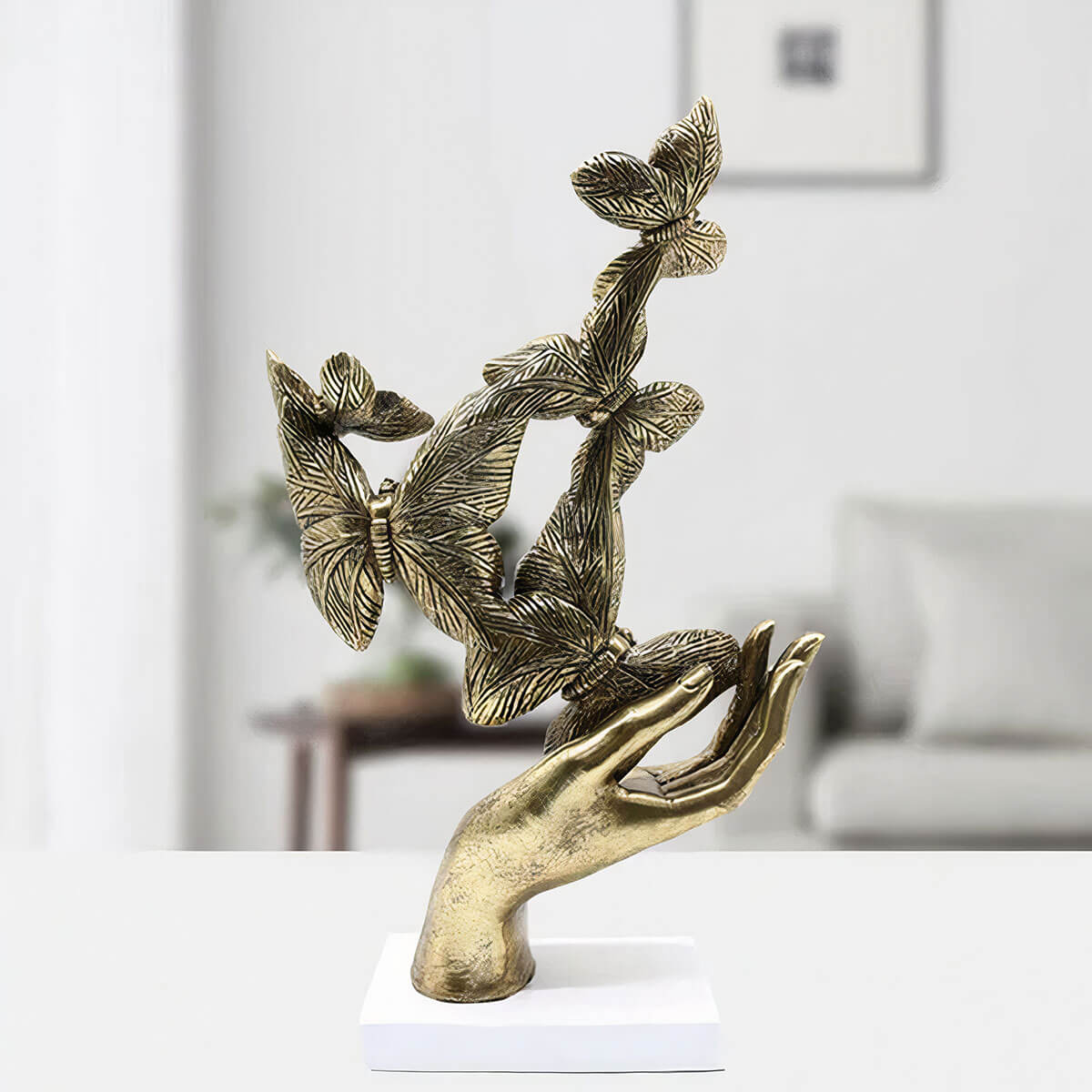 Artistic gold palm sculpture with detailed butterflies