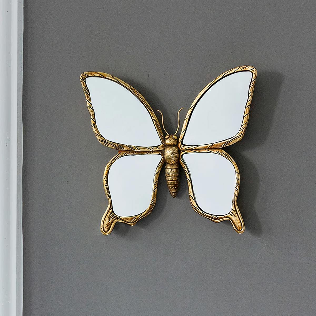 Ornate gold mirror with delicate butterfly designs