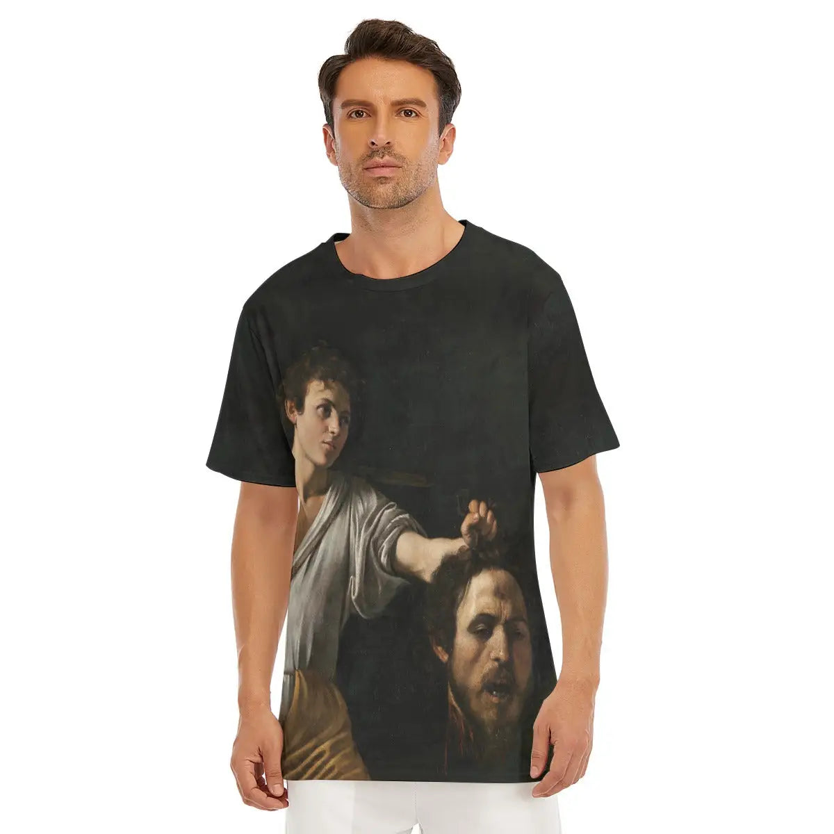Male model wearing the David with the Head of Goliath by Caravaggio All-Over Print T-shirt showcasing the dramatic chiaroscuro effect of the biblical scene with Caravaggio's own face as the severed head of Goliath