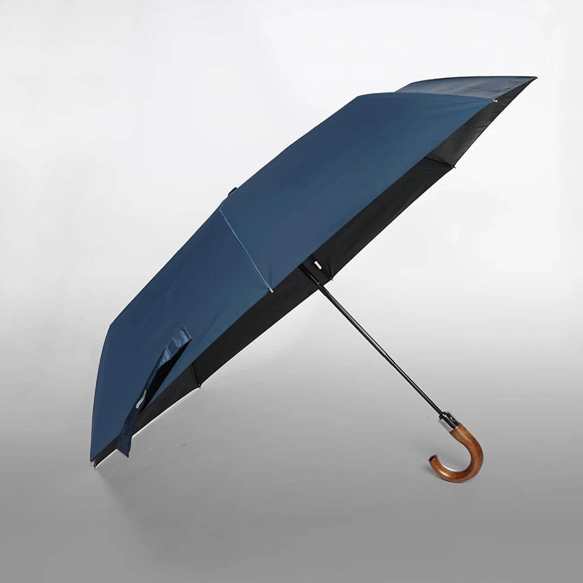 Detail of automatic folding mechanism on luxury wooden handle umbrella