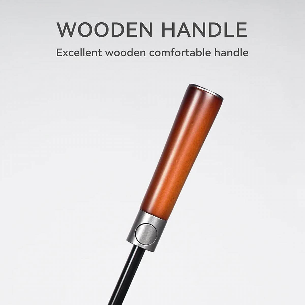 Person easily gripping wooden handle of large golf umbrella