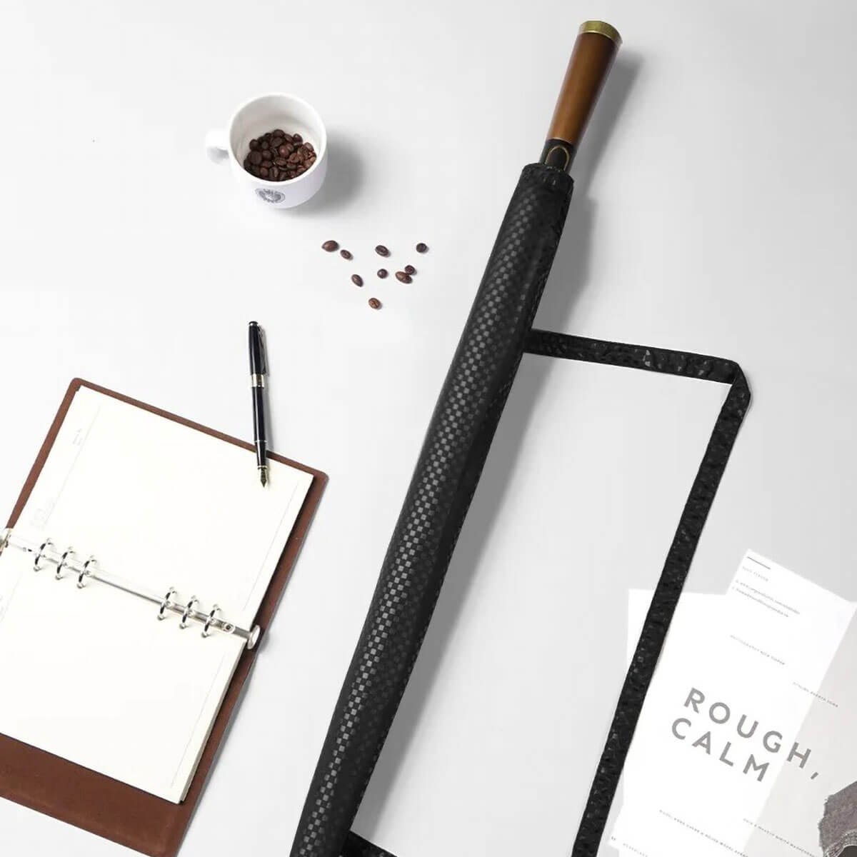 Elegant wooden handle umbrella against a backdrop of lush greenery