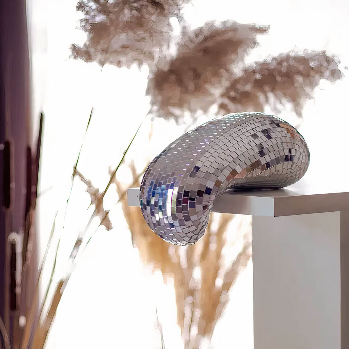 Melting Disco Ball centerpiece reflecting colorful lights in dim room