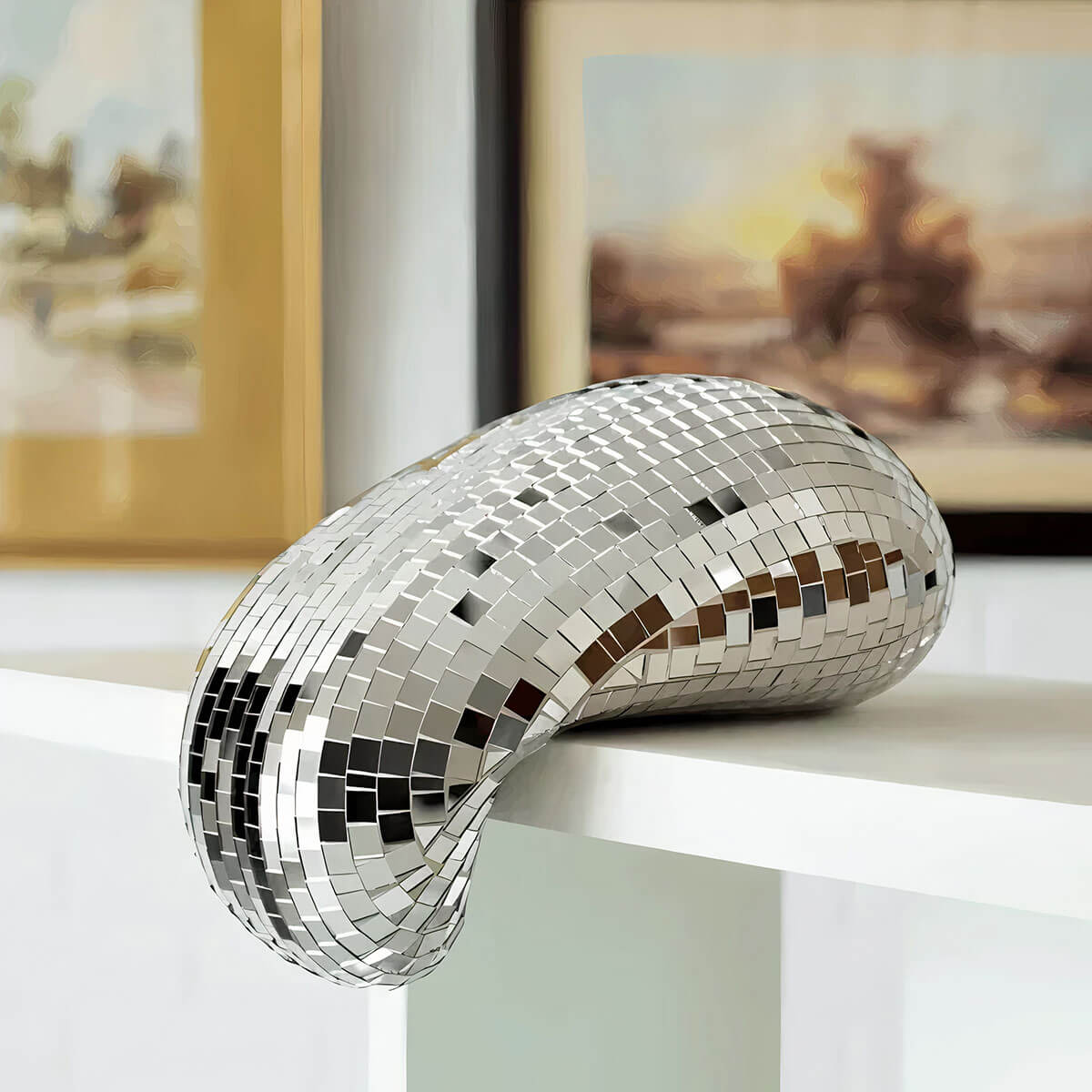 Melting Disco Ball Sculpture sparkling on table, mirrored tiles catching light