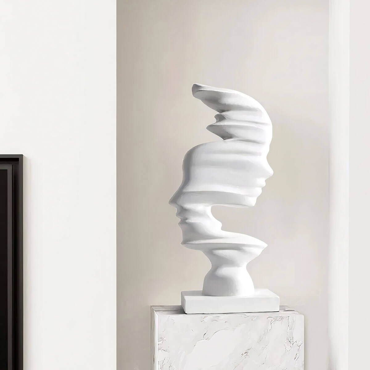 Contemporary abstract sculpture featuring intertwined faces