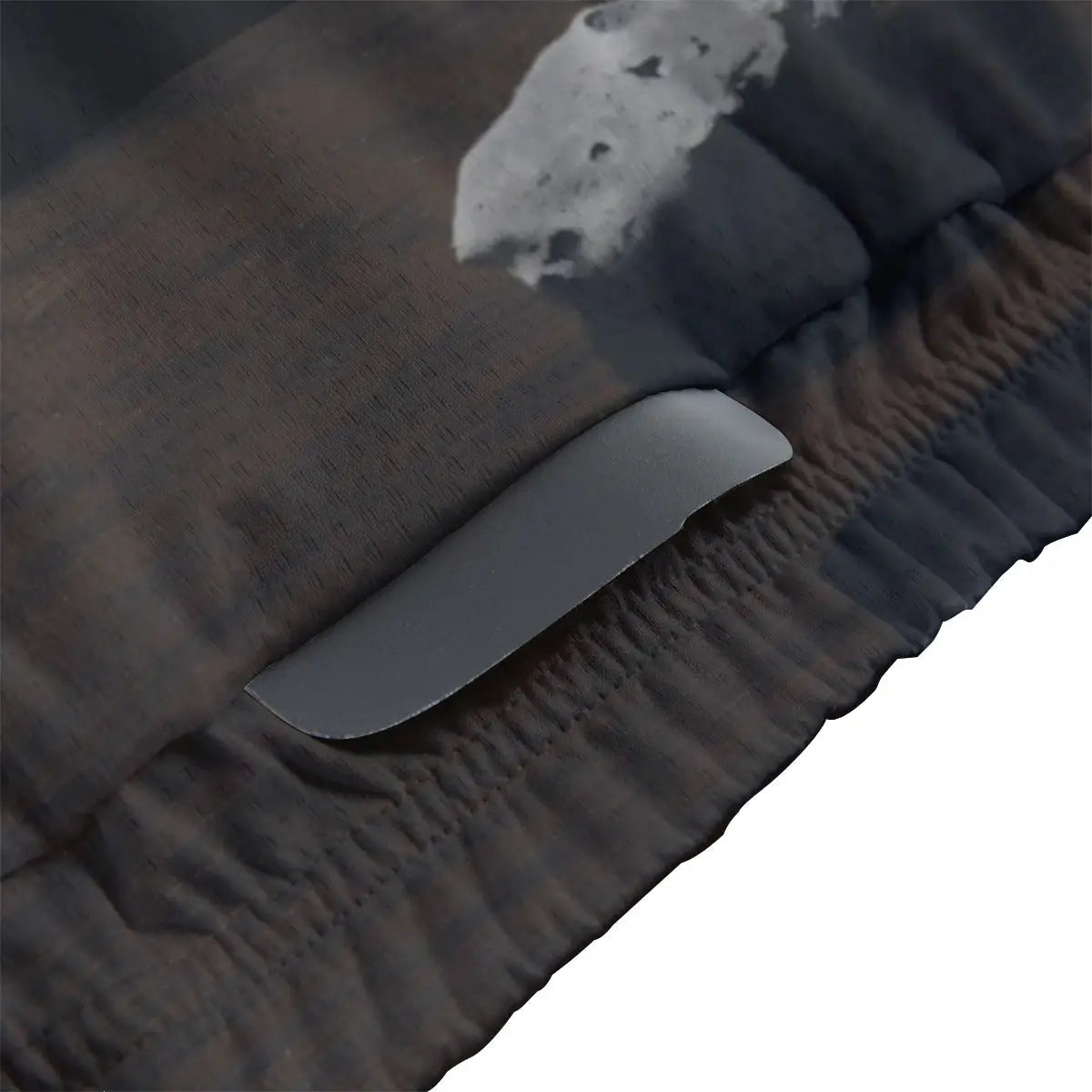 Close-up of secure non-slip rubber hem on Surrealist art cycling jersey maintaining position during conceptual ride