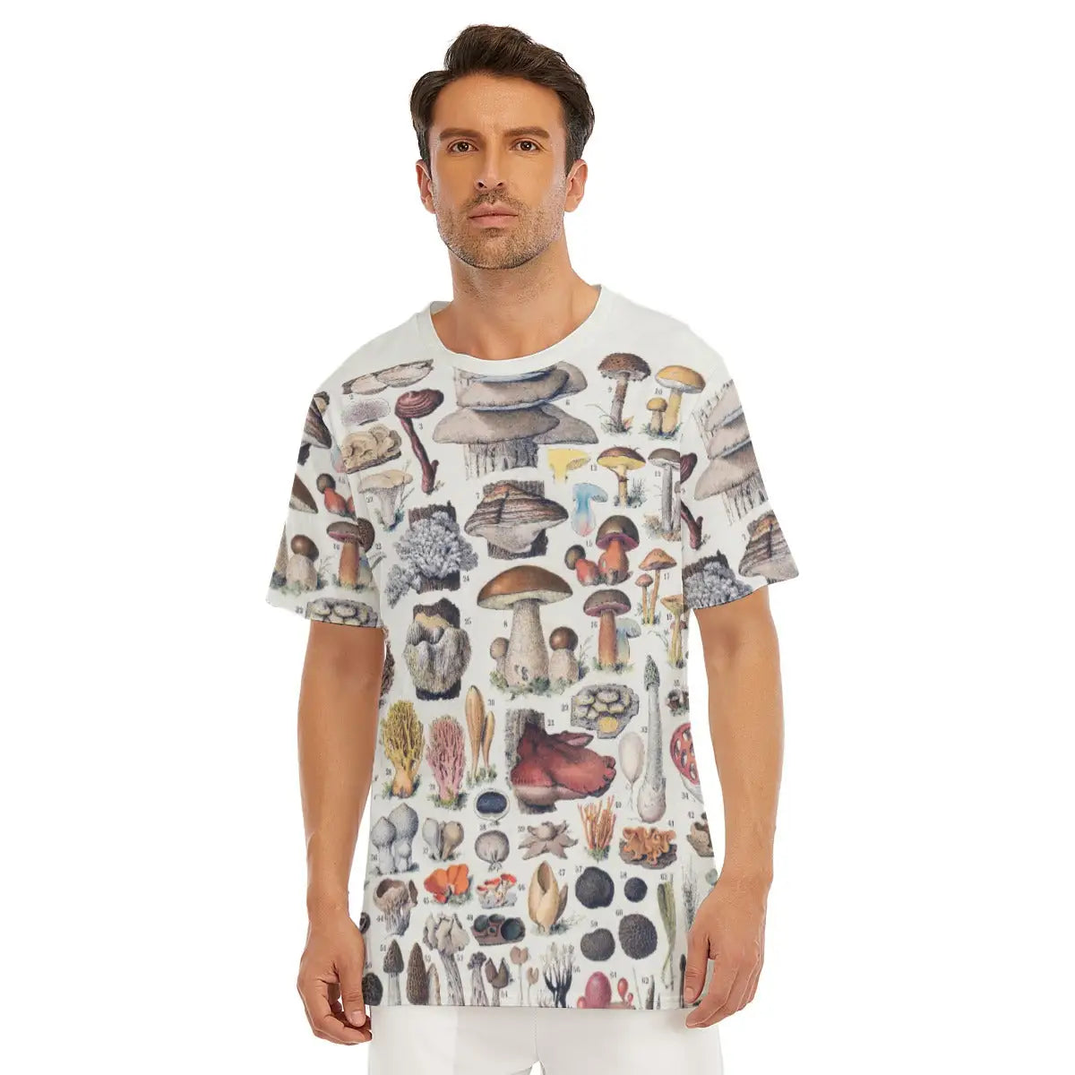 Male model wearing the Types of Mushrooms All-Over Print T-shirt showcasing a variety of detailed fungi illustrations against a neutral background on premium 100% cotton fabric
