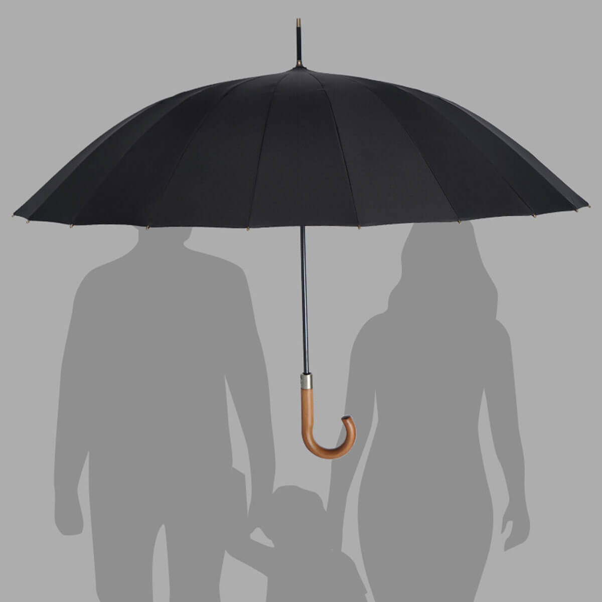 Strong wooden handle umbrella protecting multiple people from rain