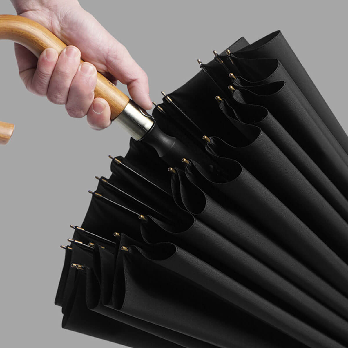 Green long rain umbrella showcasing size and wooden grip